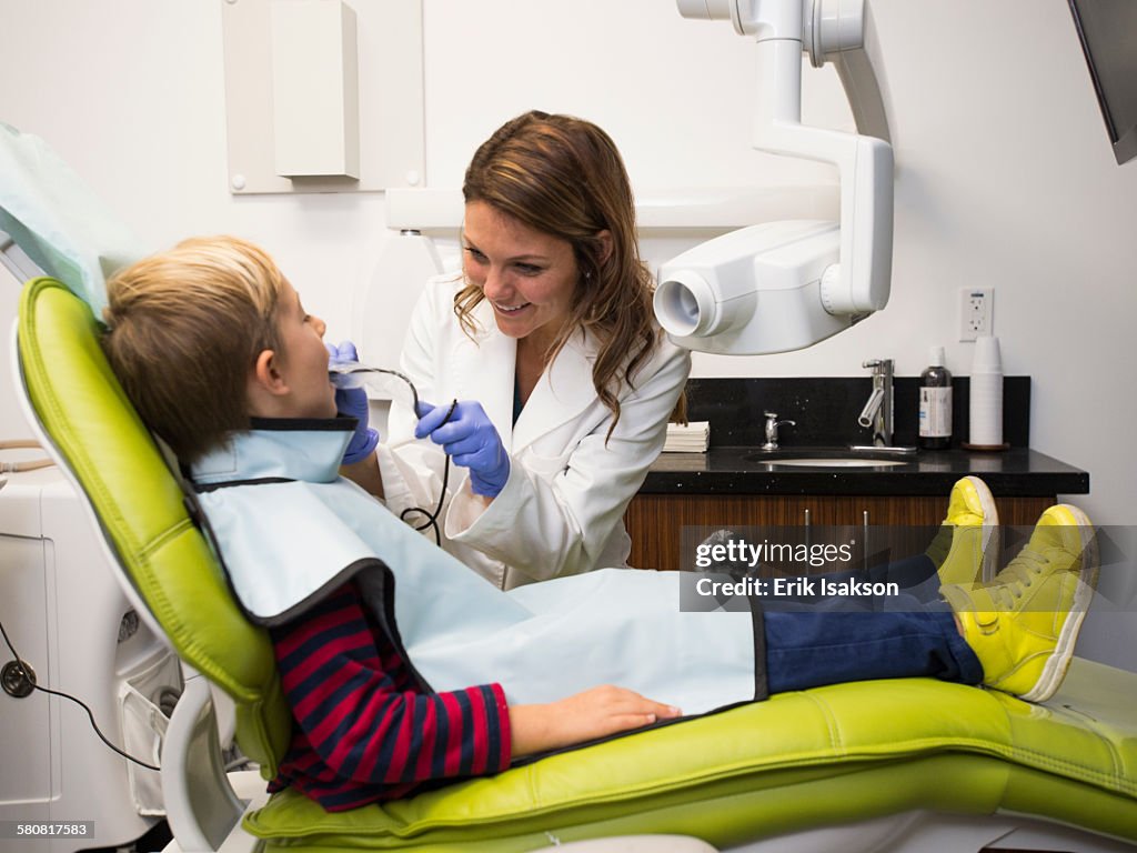 USA, California, Ladera Ranch, Dentist and patient (8-9) in dentists office