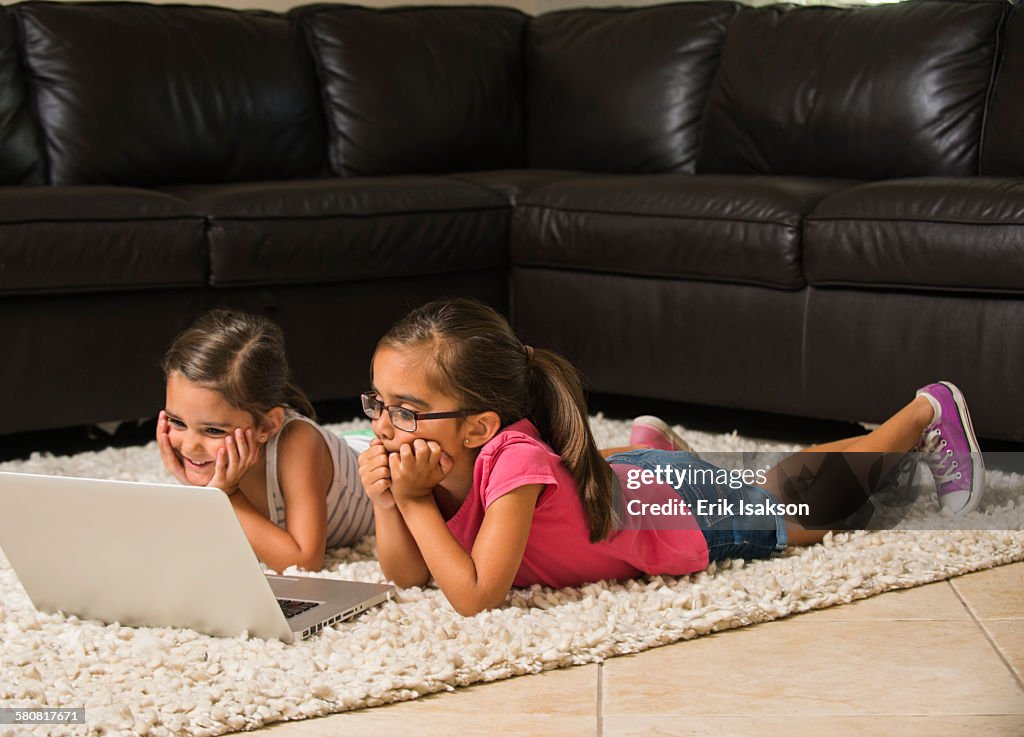 USA, California, Ladera Ranch, Girls (6-7, 8-9) using laptop at home