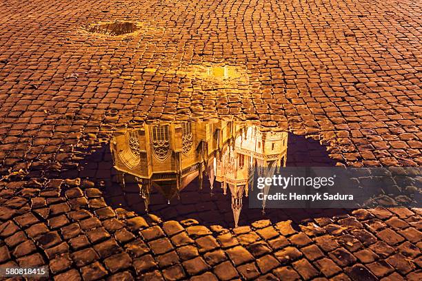 germany, thuringia, erfurt, reflection of erfurt cathedral in puddle - cobblestone puddle stock pictures, royalty-free photos & images