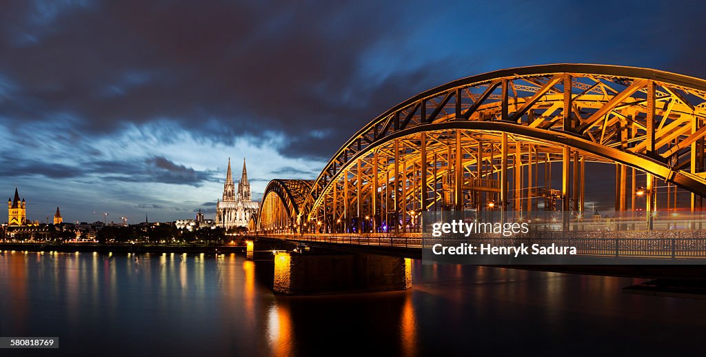 Germany, Cologne, Hohenzollern Bridge illuminated at dusk