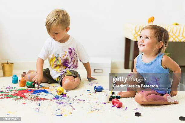 children (2-3) painting on carpet - spilled paint floor stock pictures, royalty-free photos & images