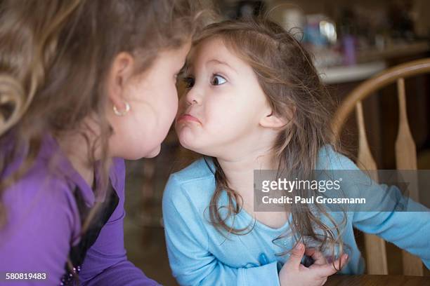 sisters making faces at each other - stubborn stock pictures, royalty-free photos & images