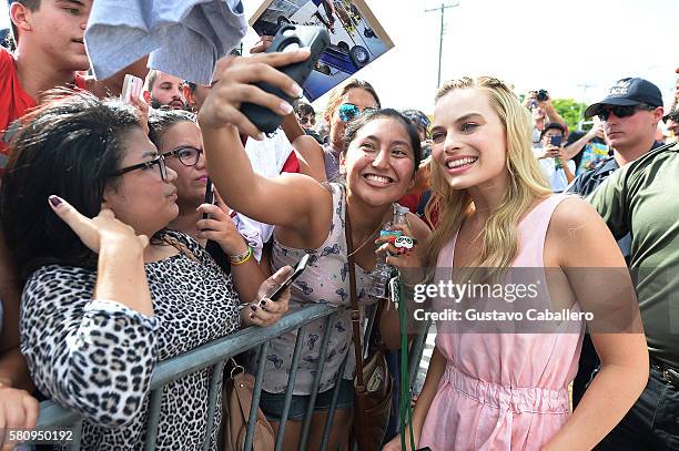 Actress Margot Robbie takes a selfie with a fan at the 'Suicide Squad' Wynwood Block Party and Mural Reveal on July 25, 2016 in Miami, Florida.