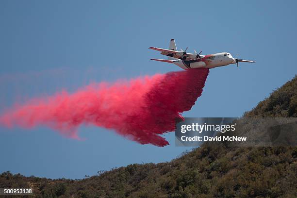 Firefighting C130 aircraft drops fire retardant in Placerita Canyon at the Sand Fire on July 25, 2016 in Santa Clarita, California. Triple-digit...