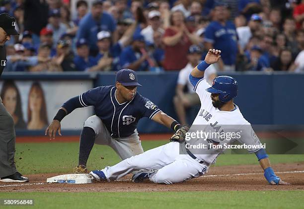 Jose Bautista of the Toronto Blue Jays slides safely into third base as he advances on an RBI single by Josh Donaldson in the fifth inning during MLB...