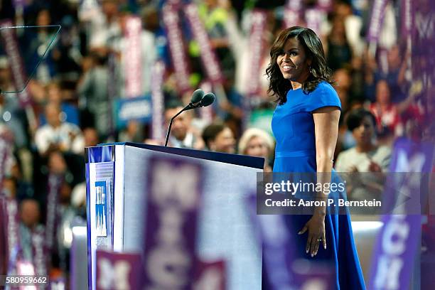First lady Michelle Obama walks on stage to deliver remarks on the first day of the Democratic National Convention at the Wells Fargo Center, July...