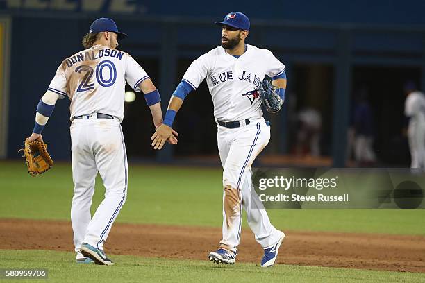 Josh Donaldsonand Jose Bautista congratulate each other at the end of the game as the Toronto Blue Jays beat the San Diego Padres 4-2 at the Rogers...