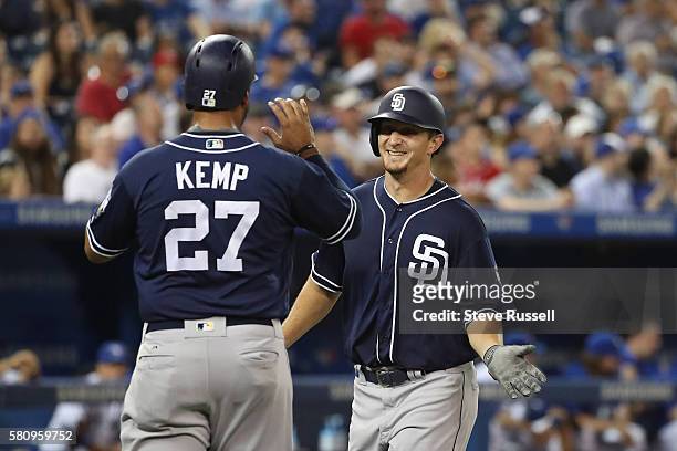 San Diego Padres left fielder Alex Dickerson celebrates a two run homer into the fifth deck as the Toronto Blue Jays beat the San Diego Padres 4-2 at...