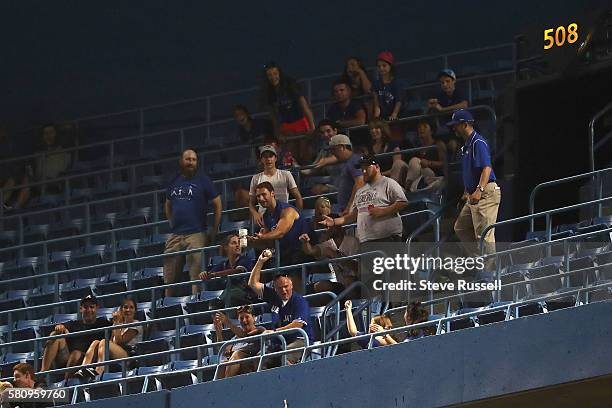 Fan comes up with San Diego Padres left fielder Alex Dickerson's two run homer into the fifth deck as the Toronto Blue Jays beat the San Diego Padres...