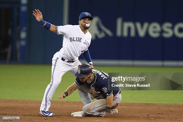 With Travis Jankowski sliding in Toronto Blue Jays second baseman Devon Travis turns the double play in the eighth inning as the Toronto Blue Jays...
