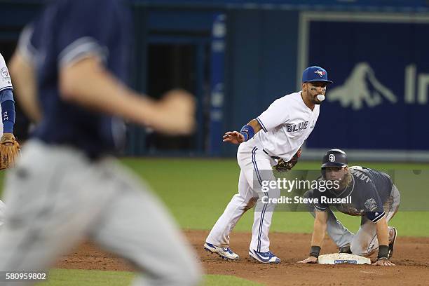 With Travis Jankowski sliding in Toronto Blue Jays second baseman Devon Travis turns the double play in the eighth inning as the Toronto Blue Jays...