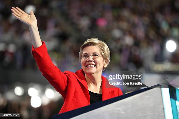 Sen. Elizabeth Warren acknowledges the crowd as she walks on stage to deliver remarks on the first day of the Democratic National Convention at the...