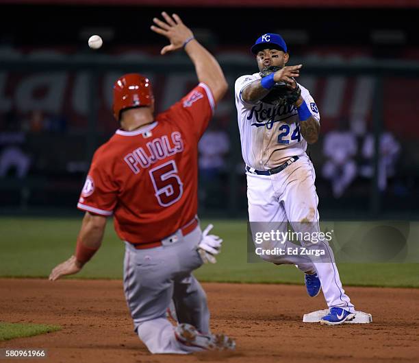 Christian Colon of the Kansas City Royals throws to first over Albert Pujols of the Los Angeles Angels of Anaheim to complete a double play in the...