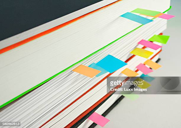 view of books with colourful dividers between page - indexing stock-fotos und bilder