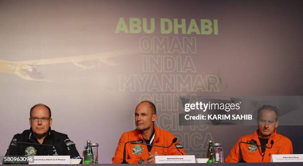 Monaco's Prince Albert II, pilots Bertrand Piccard and Andre Borschberg attend a press conference after the Solar Impulse 2 aircraft landed at Al...