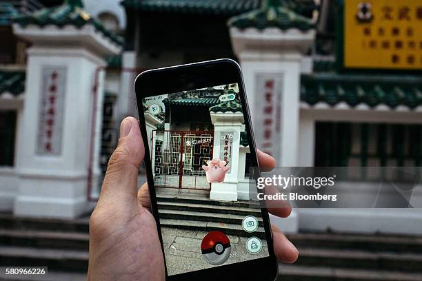 The Clefairy character of Nintendo Co.'s Pokemon Go augmented-reality game, developed by Niantic Inc., is seen in front of Man Mo Temple on a...