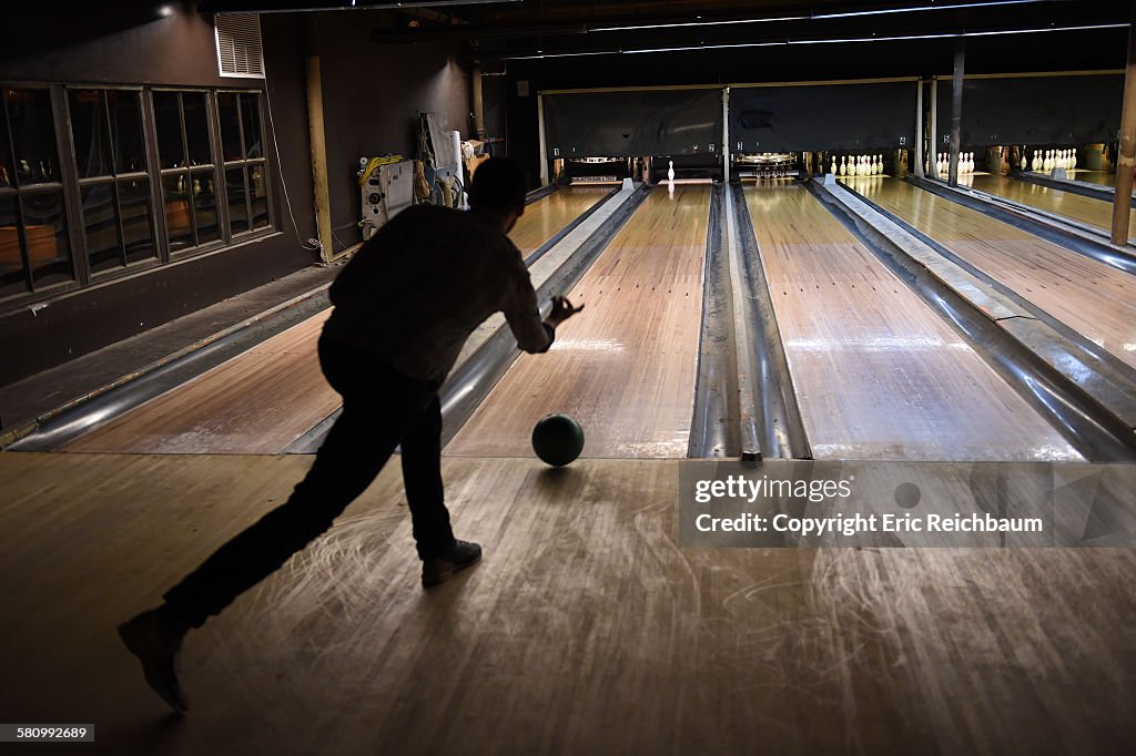 Silhoutted Man Bowling