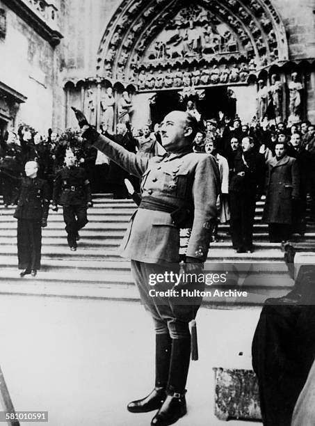 Spanish Nationalist leader General Francisco Franco salutes during the singing of the Nationalist national anthem at Burgos Cathedral, Castile,...