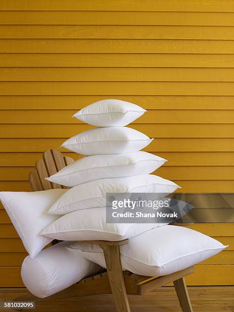 stack of pillows on adirondak chair - bedding stock pictures, royalty-free photos & images