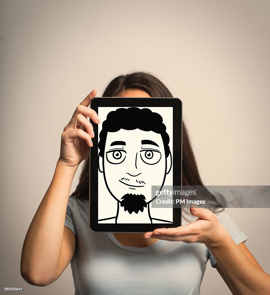 Woman hiding identity with tablet