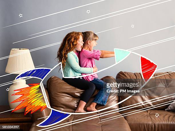 riding on a sofa rocketship - dreamlike stock pictures, royalty-free photos & images