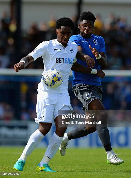 Leroy Fer of Swansea City is tackled by Ellis Harrison of Bristol Rovers during the Pre-Season Friendly match between Bristol Rovers and Swansea City...