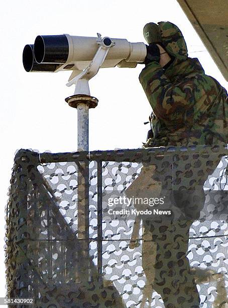 South Korea - A South Korean Marine stands watch on Yeonpyeong Island, South Korea, on Dec. 26, 2011.