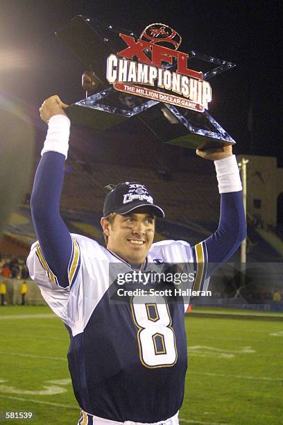 Tommy Maddox of the Los Angeles Xtreme celebrates with the XFL Championship trophy after defeating the San Francisco Demons 38-6 in the XFL...