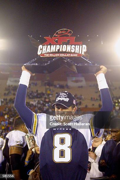 Tommy Maddox of the Los Angeles Xtreme celebrates with the XFL Championship trophy after defeating the San Francisco Demons 38-6 in the XFL...