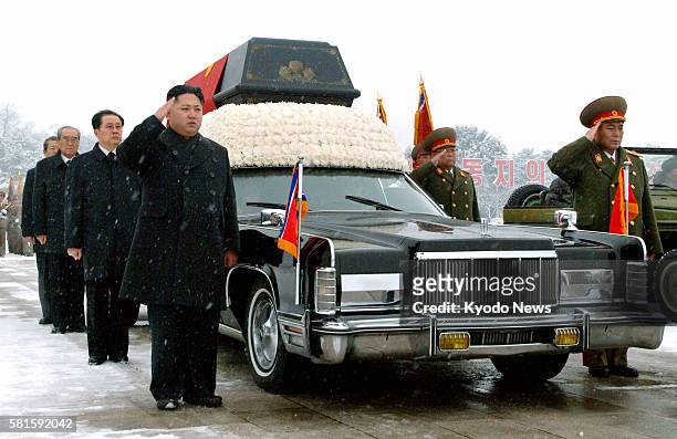 North Korea - Kim Jong Un , son of the late North Korean leader Kim Jong Il and his successor, salutes beside the hearse carrying the coffin of the...