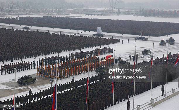 North Korea - A funeral motorcade for Kim Jong Il passes through the square in front of the Kumsusan Memorial Palace, in Pyongyang, where soldiers of...