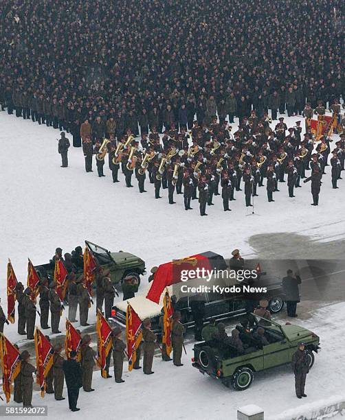 North Korea - A hearse carrying the coffin of Kim Jong Il passes through the square in front of the Kumsusan Memorial Palace in Pyongyang, with...