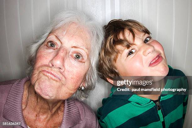 grandmother and grandson making funny faces - making a face stock-fotos und bilder