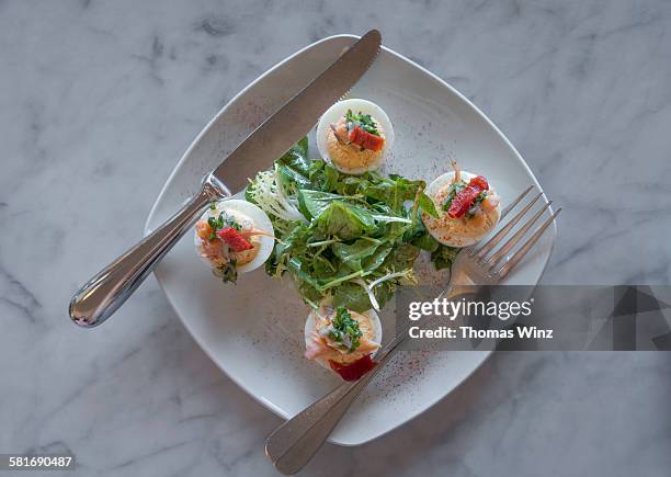 deviled eggs and mixed greens - deviled eggs stock pictures, royalty-free photos & images