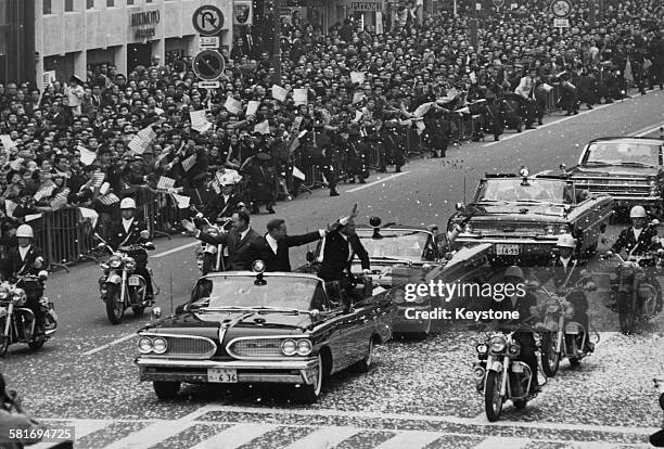 The three US astronauts from the Apollo 11 mission take part in a tickertape parade in the Ginza, Tokyo, during a two-day visit to Japan on their...