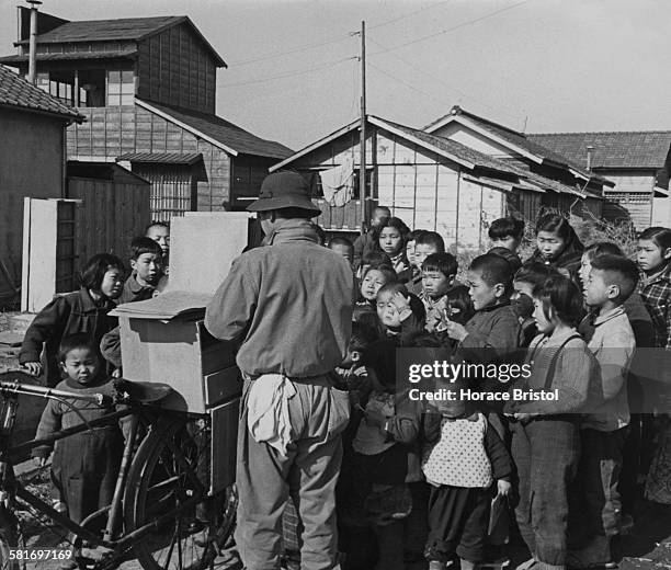 Outcaste Burakumin children in an etamura or eta town watching a Kamishibai puppet show, during the post-war Allied occupation of Japan, circa 1950.