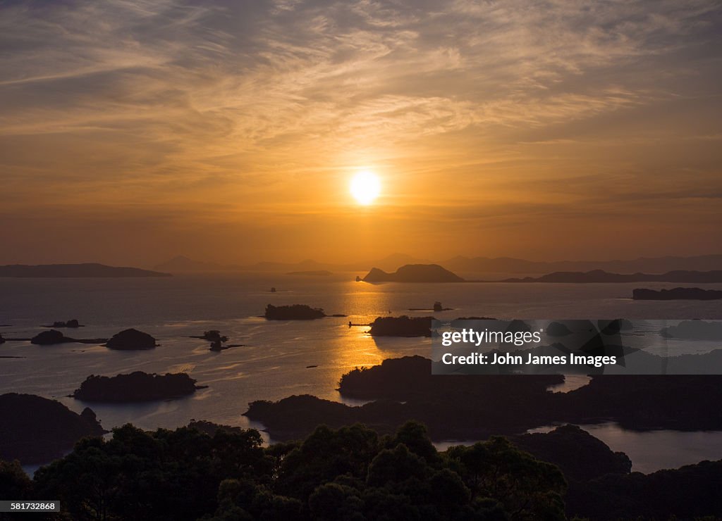 Orange sunset over islands and sea