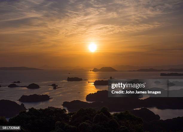 orange sunset over islands and sea - kujuku islands stock pictures, royalty-free photos & images