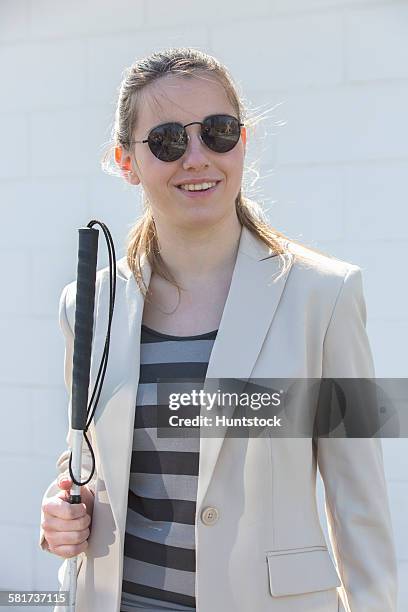 young blind woman smiling with her cane - 白杖 ストックフォトと画像