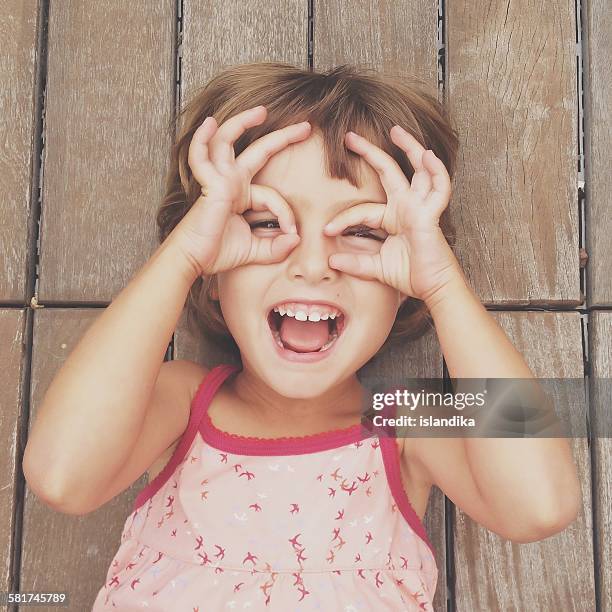 girl looking through finger frames - taken on mobile device stock pictures, royalty-free photos & images