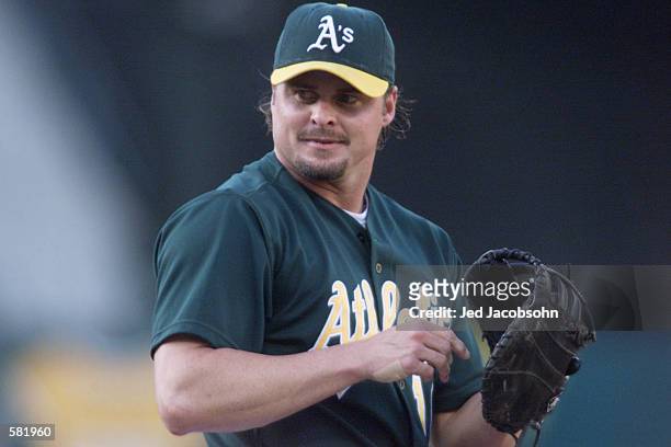 Jason Giambi of the Oakland Athletics prepares to throw a pitch against the Los Angeles Dodgers during the game at Network Associates Coliseum in...