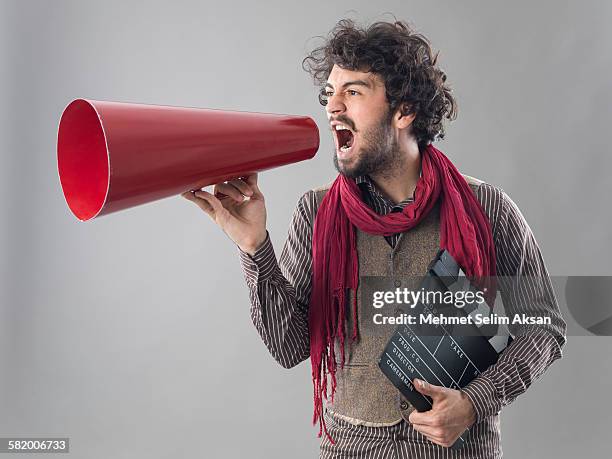 young film director shouting through megaphone - film director stock pictures, royalty-free photos & images