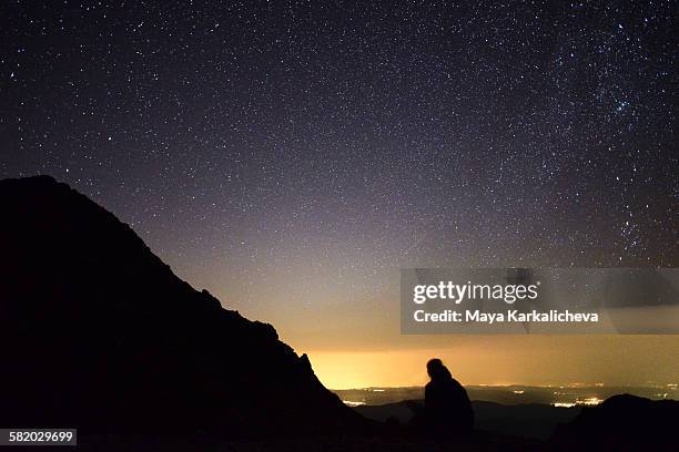 silhouette of a man at stary night in a mountain - stary night stock pictures, royalty-free photos & images