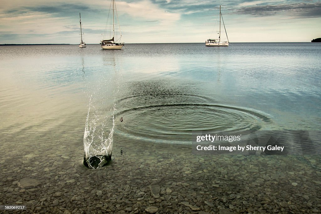 Skipping stones in a crystal clear bay