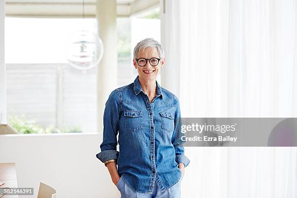 portrait of modern mature woman at home - woman shirt stock pictures, royalty-free photos & images