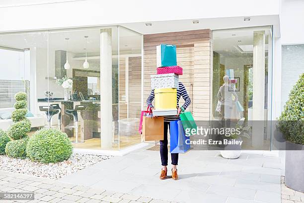 woman hidden by her shopping bags and boxes - consumerism foto e immagini stock