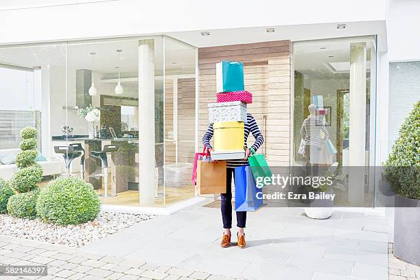 woman hidden by her shopping bags and boxes - abundance stock pictures, royalty-free photos & images