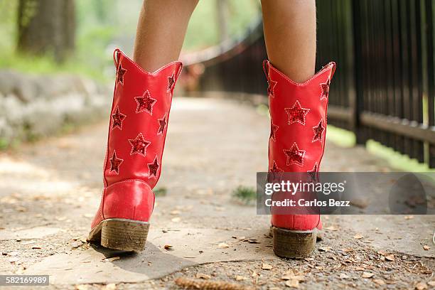 cowgirl with red boots - red boot stock pictures, royalty-free photos & images