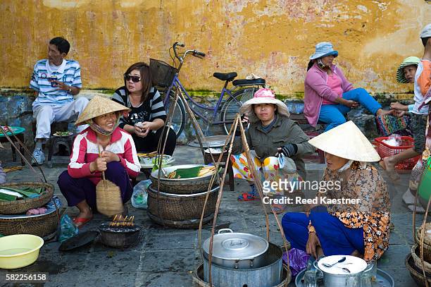 a group of vietnamese women take a lunch break on the street in ho chi minh city, vietnam - hot vietnamese women stock pictures, royalty-free photos & images