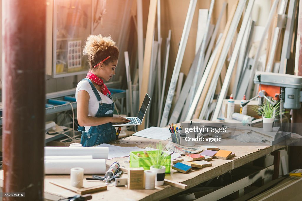 Latina Carpenter Standing In Her Workshop
